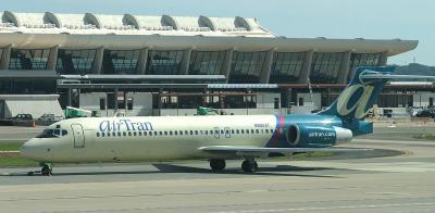 AirTran  717 with IAD terminal in the background