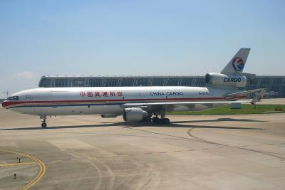 MU Cargo MD-11 at Shanghai PVG, with the new terminal building as the background