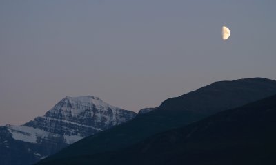 The light fades quietly over Mt. Edith Carvell, while the half moon rises