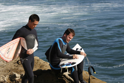 Surfers waxing their boards on a cliff in Santa Cruz