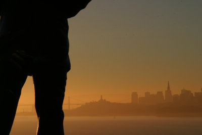 Part of San Francisco's Lone Sailor with the city beyond