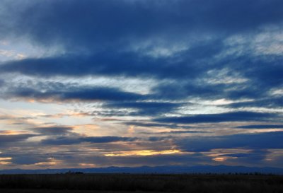 Sunset over Denver (skyscrapers visible in the center of the horizon)