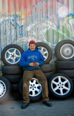 worker poses before tires
