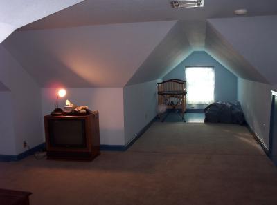 The same room, but a few years earlier when Chris had the whole thing by himself. From this view, I'm in the smallest wing (dormer window above the livingroom bay window), looking across the 'square' and down to the other wing. Total distance from the window at my back to the opposite window shown in this picture is a 35-ft distance!!!