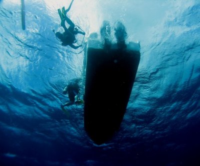 Divers getting on the boat after a great dive