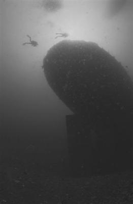 Two divers approach the sunken stern (note the rudder).