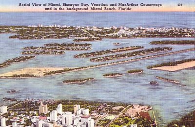 1940's - aerial view of downtown, MacArthur Causeway, Venetian Causeway, Biscayne Bay and Miami Beach