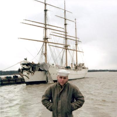 1967 - SN Don Boyd in front of the damaged Coast Guard Barque EAGLE (WIX-327) at the Coast Guard Yard, Curtis Bay, Maryland
