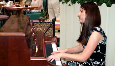 Jim's daughter Katie Criswell playing the piano during dinner photo, #7273