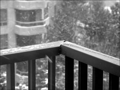 Snow falling on the balcony