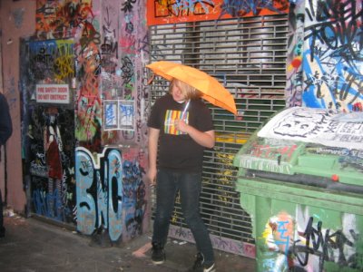 9 may Young man with orange umbrella