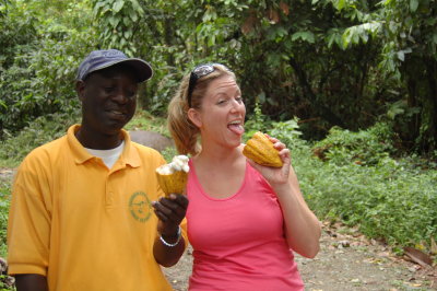 Tour guide Tony and Aimee tasting a cocoa pod