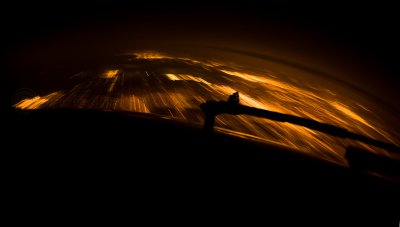 The night-lit cities gliding underneath