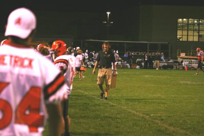coach giesting paces on the sideline