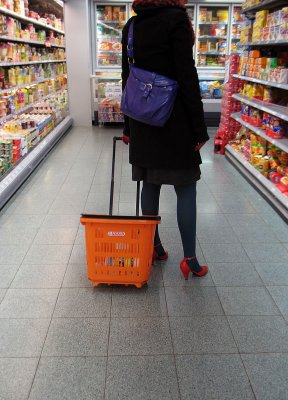 red shoes, orange shopping bag on wheels and purple bag