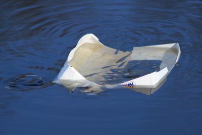 Someones trash in the pond has been put to good use by these fish.....protection!