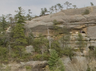 Hikers in the outer window of cave/arch