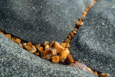 Small Pebbles Between Granite Slabs