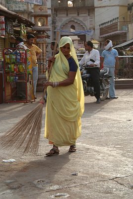 Woman in Yellow Sweeping
