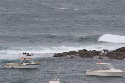 Surfers and boats