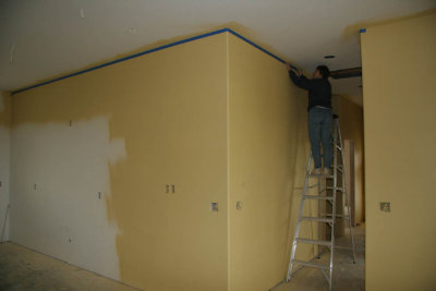 Carol masking the walls before we spray the ceilings