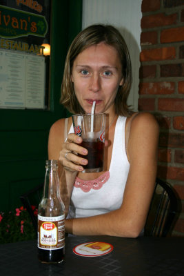 Nadia drinks root beer.