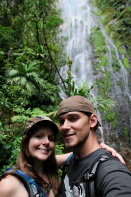 Happy couple enjoying the waterfall