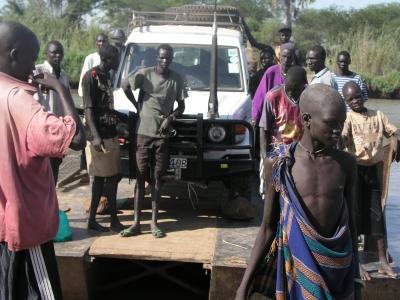 Car crossing the river by raft.