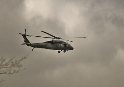 Military helicopter carrying the Governor to see the damage