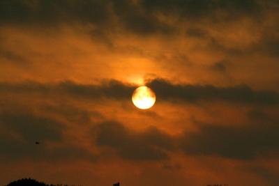 SUN RISING BETWEEN THE CLOUDS ON 040506