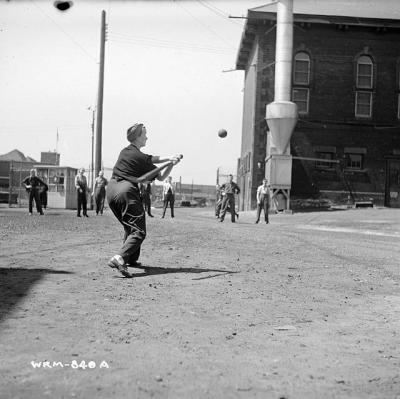 Workers play a game of baseball