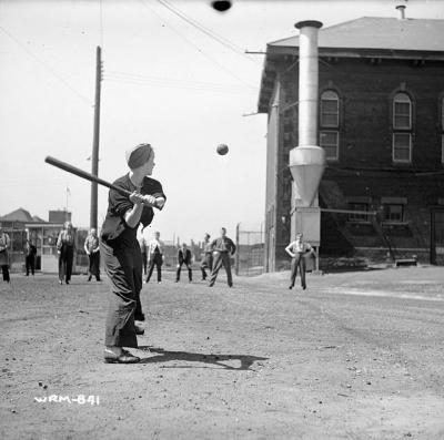 Workers play a game of baseball