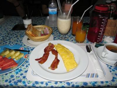 breakfast Sunday morning @ Tuptim's, Banana Milkshake 45B,2 egg omlet, bacon, OJ, toast butter jam and tea for 120b
