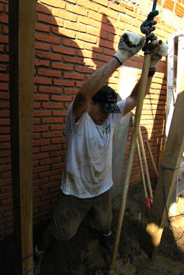 John man-handling the drilling rig