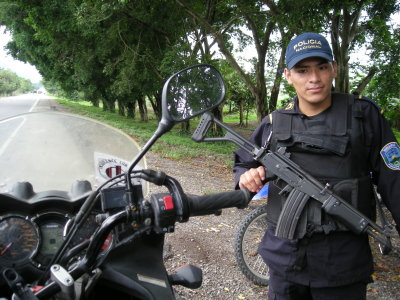 Honduran police, a sweet Galil !  AK47's are reliable pieces of junk but check out the modified charging handle and mag release.