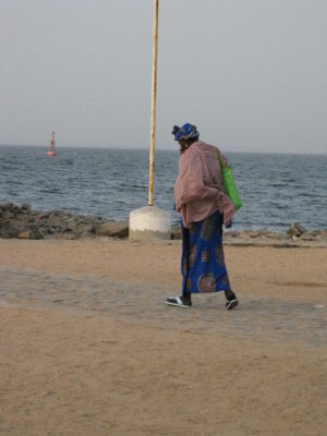 088 Woman walking to ferry at Goree.jpg