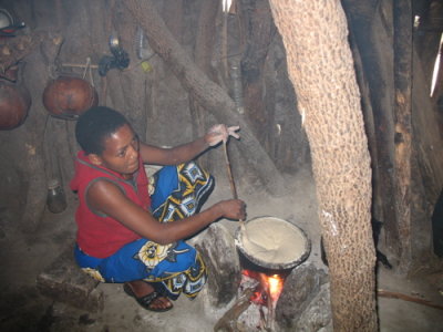 Iraqw woman cooking Ugali