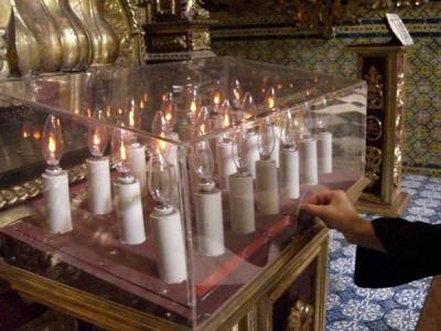 Technology finds its way into church. Just throw in a coin to light a candle.