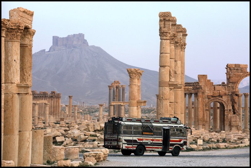 Early local bus passing the Palmyra ruins