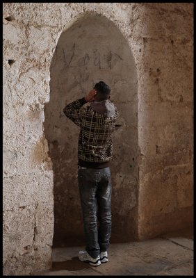 Young boy demonstrating a prayer song inside Krak des Chevalier