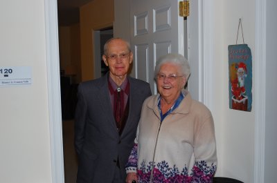 Fran & Romer at the front door of their Apt