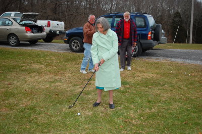 Mom showing her boys how to play the game