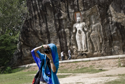 Photographing before the carved Buddhas of Wellawaya