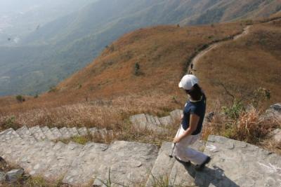 Joyce heading down steep stairs to Hok Tau