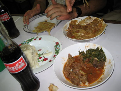 A typical meal for us - goat stew, ugali, chipati, fried veges of some sort, and a coke.