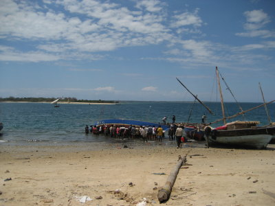 Local men trying to free a grounded fishing boat on the beach at Mtwara.