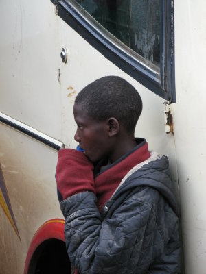 Street boy sniffing glue at the Nakuru bus terminal.