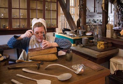 Tinsmith hammering decorative piece