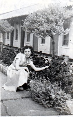 Mary pinching flowers from someome's garden
