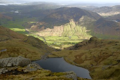 Stickle Tarn foreground from top of Pavey Ark with Windermere top left and Blea Tarn followed by Little Langdale valley right